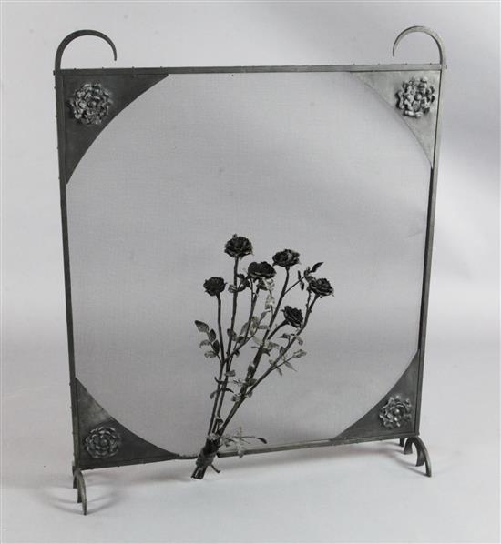 A black painted free standing wrought iron spark guard, W.2ft 9.5in